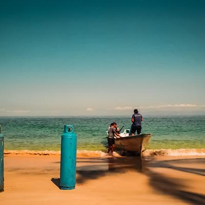 Boat and gas cylinder on the beach