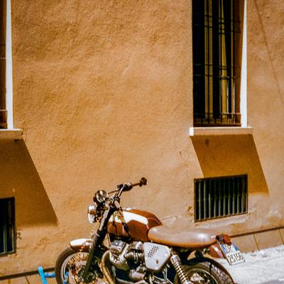 Motorcycle against an ochre wall