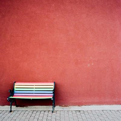 Bench against a red wall